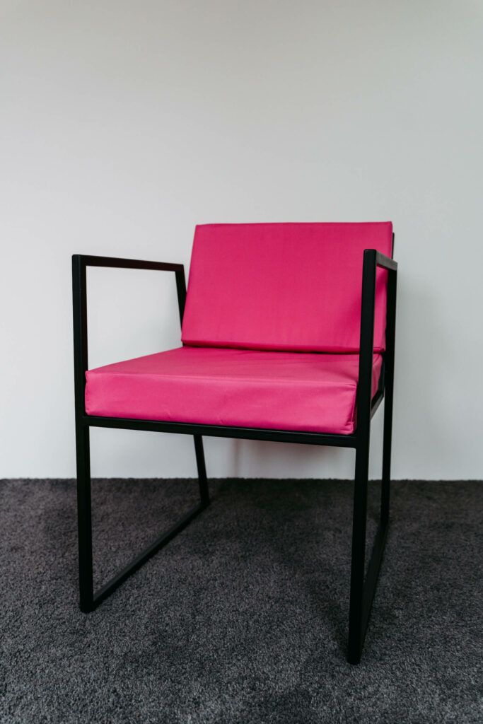 Schwarzer Loungesessel mit pinker Sitzfläche